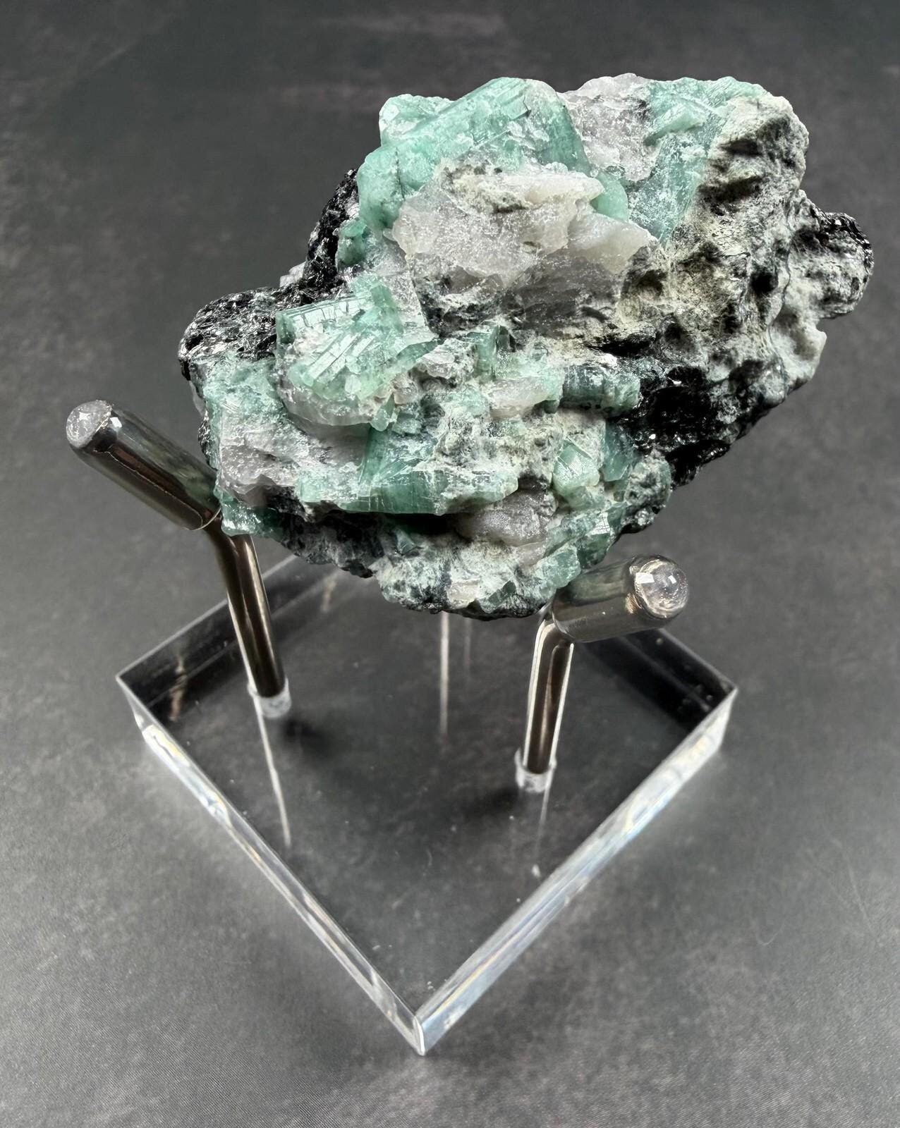Emerald crystal cluster on quartz and black mica mineral specimen